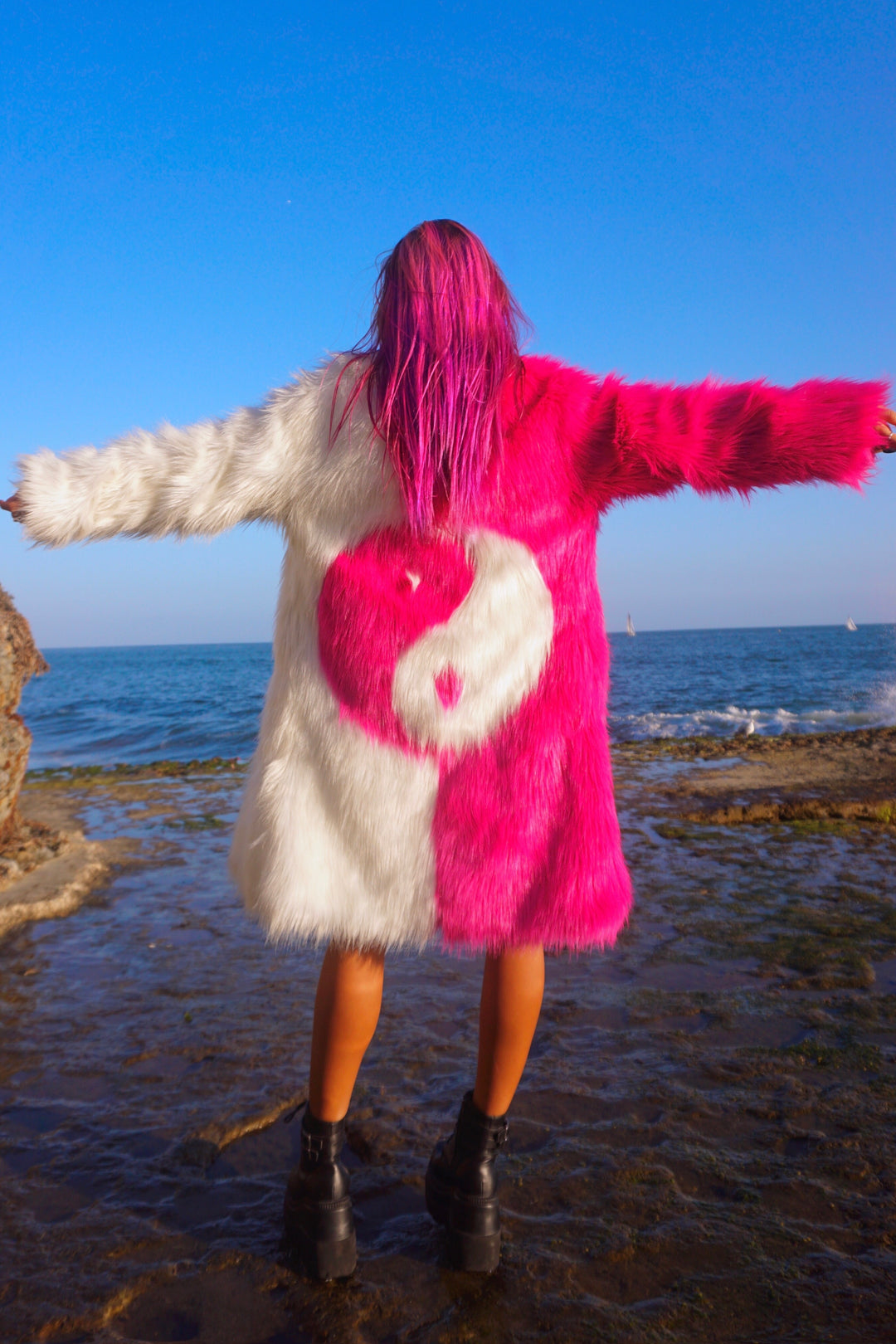 Yin Yang coat black and pink faux fur by Space island. Shop area 51 alien face coat, Yin yang black and white coats, rainbow neon fur coats. Spvce Island is a wearable art collective featuring festival fashion, rave wear, club wear and streetwear. Buy coats, jackets, platform boots, gogo boots, rainbow platform sneakers, holographic sandals, shoes, burning man goggles, crystal chokers, holographic corsets, joggers, rave bottoms, bikinis, harnesses, bondage and more.