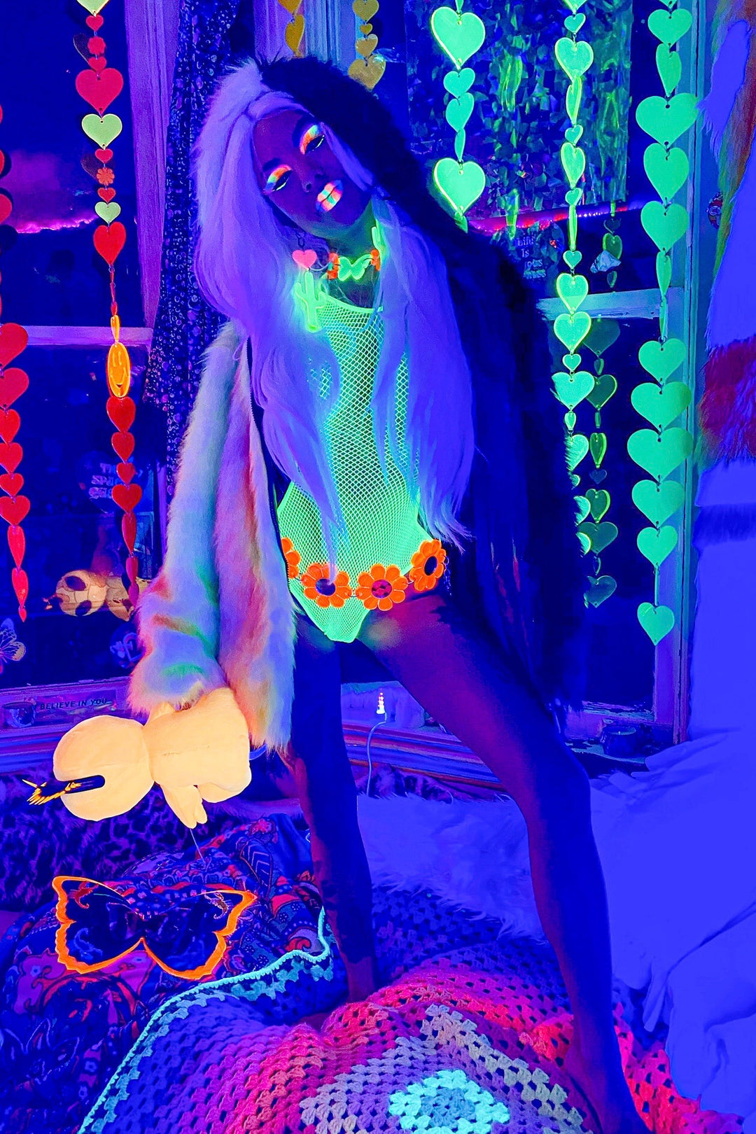 Area 51 alt text: Area 51 Alien face coat black and neon rainbow faux fur by Space island. Spvce Island is a wearable art collective featuring festival fashion, rave wear, club wear and streetwear. Buy coats, jackets, platform boots, gogo boots, rainbow platform sneakers, holographic sandals, shoes, burning man goggles, crystal chokers, holographic corsets, joggers, rave bottoms, bikinis, harnesses, bondage and more. 